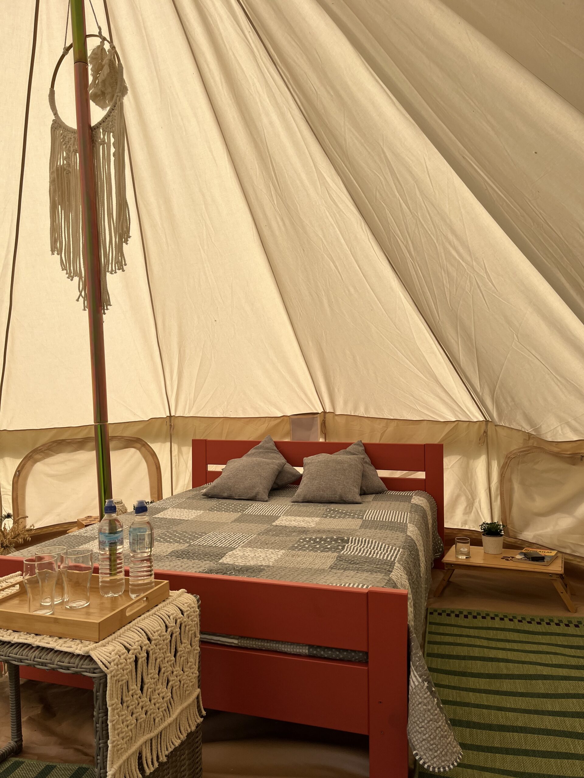 Interior view of a cozy glamping cabin with a bed at Jantsu Farm
